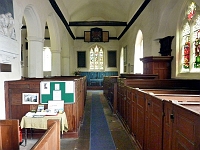 Nave and pulpit, St James Church. The pulpit is oak and dates to the 16th century. Photo 2010.
