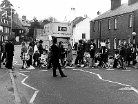 Demonstration for a bypass for Stanstead Abbotts. We would walk back and forth across the crossing forcing traffic to build up. The police used to clear the road when the hold up became excessive. Traffic through the village was non stop as it was the main A414 to Harlow. Photo April 1975. The bypass finally opened in 1987.