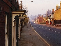 Stanstead Abbotts High Street. The door on the left is entrance to the Pied Bull. Around 1978
